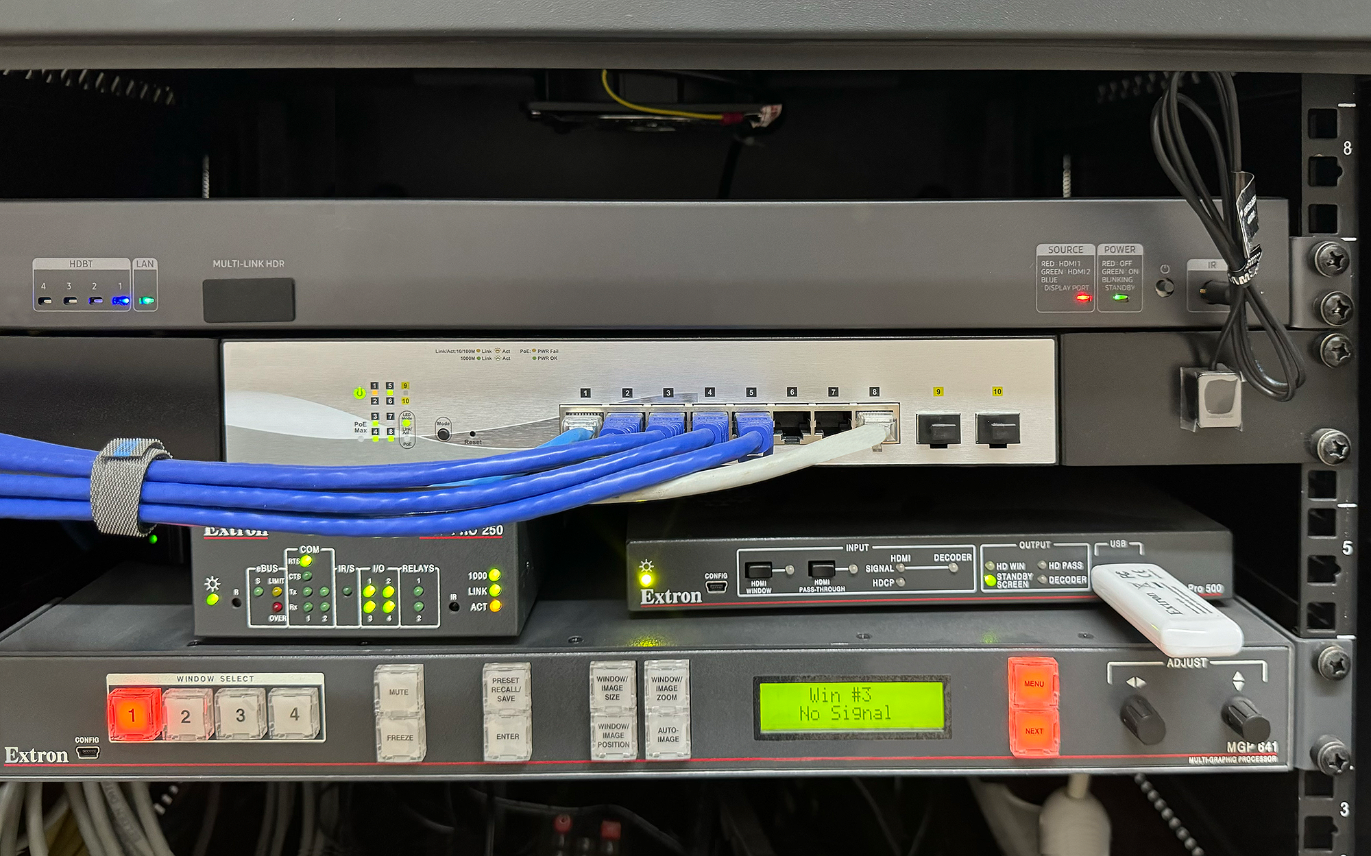 The central components for AV signal processing, distribution, streaming, and control fit easily in the table at the front of the main room. 