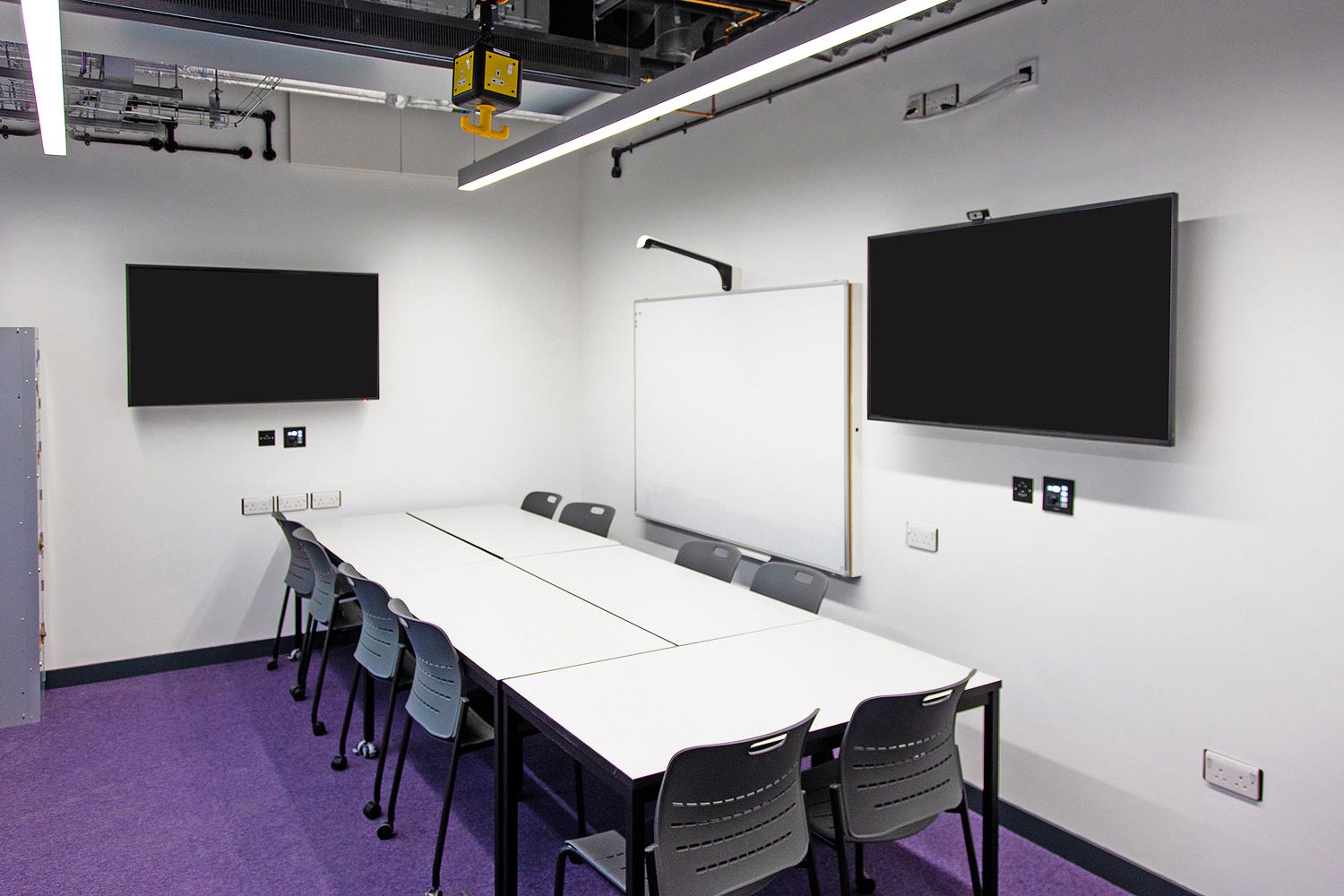 Student spaces provide access to the same resources as classrooms. An Extron MediaLink controller and a network button panel enable source selection and local display control.