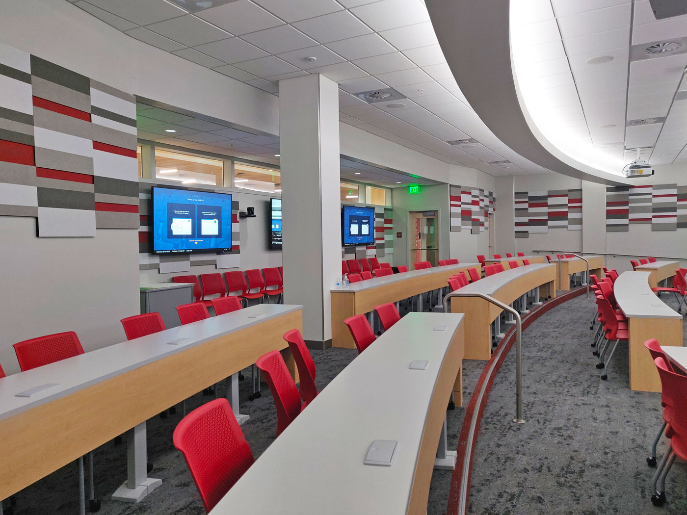 The Lecture Hall scales-up the standard classroom AV system design to include more displays, more microphones, more user interface touchpanels, multiple cameras, and a UC codec for video conferencing.