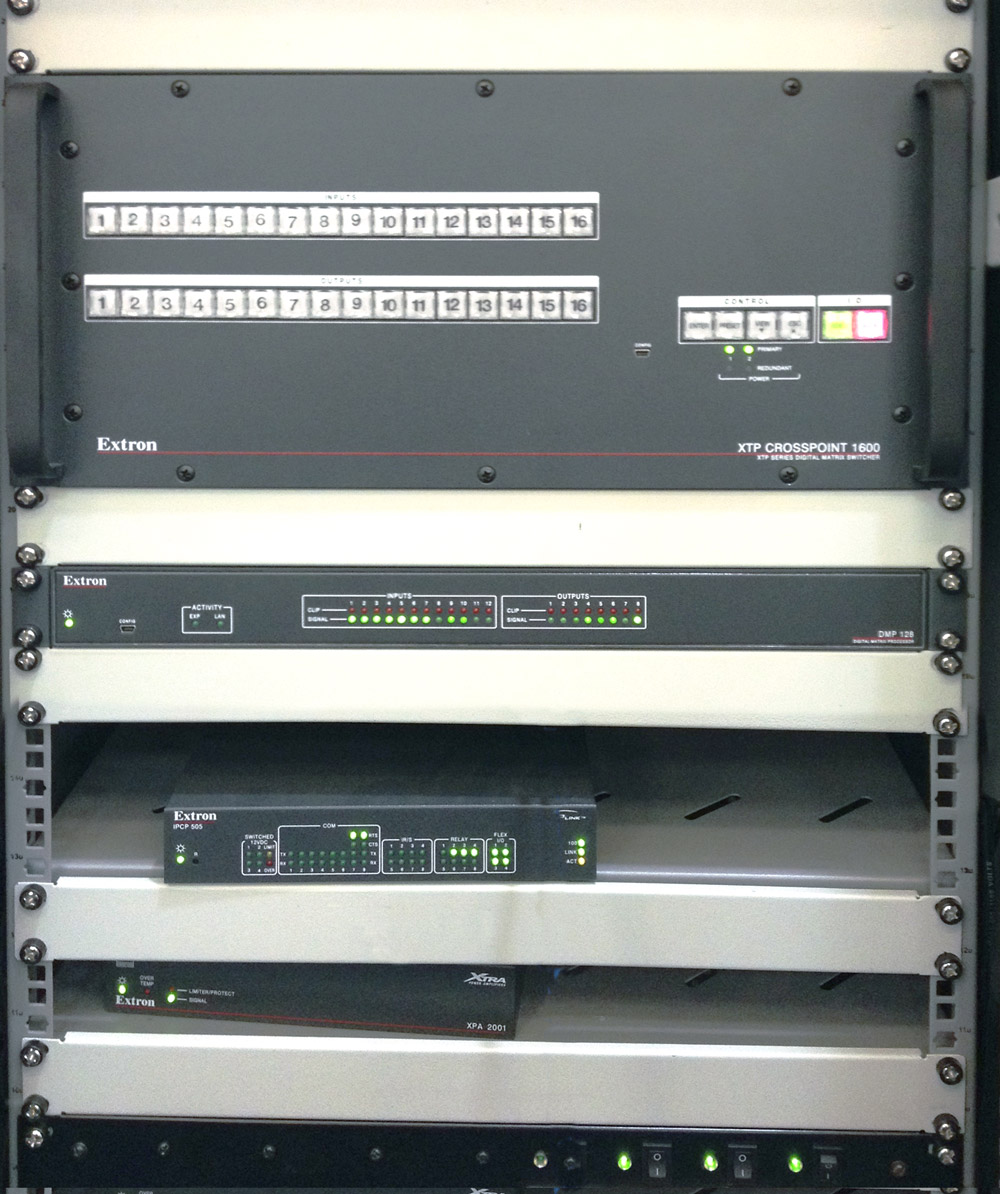 A single XTP CrossPoint 1600 provides AV and control signal switching and distribution within the four-way divisible boardroom and training space.