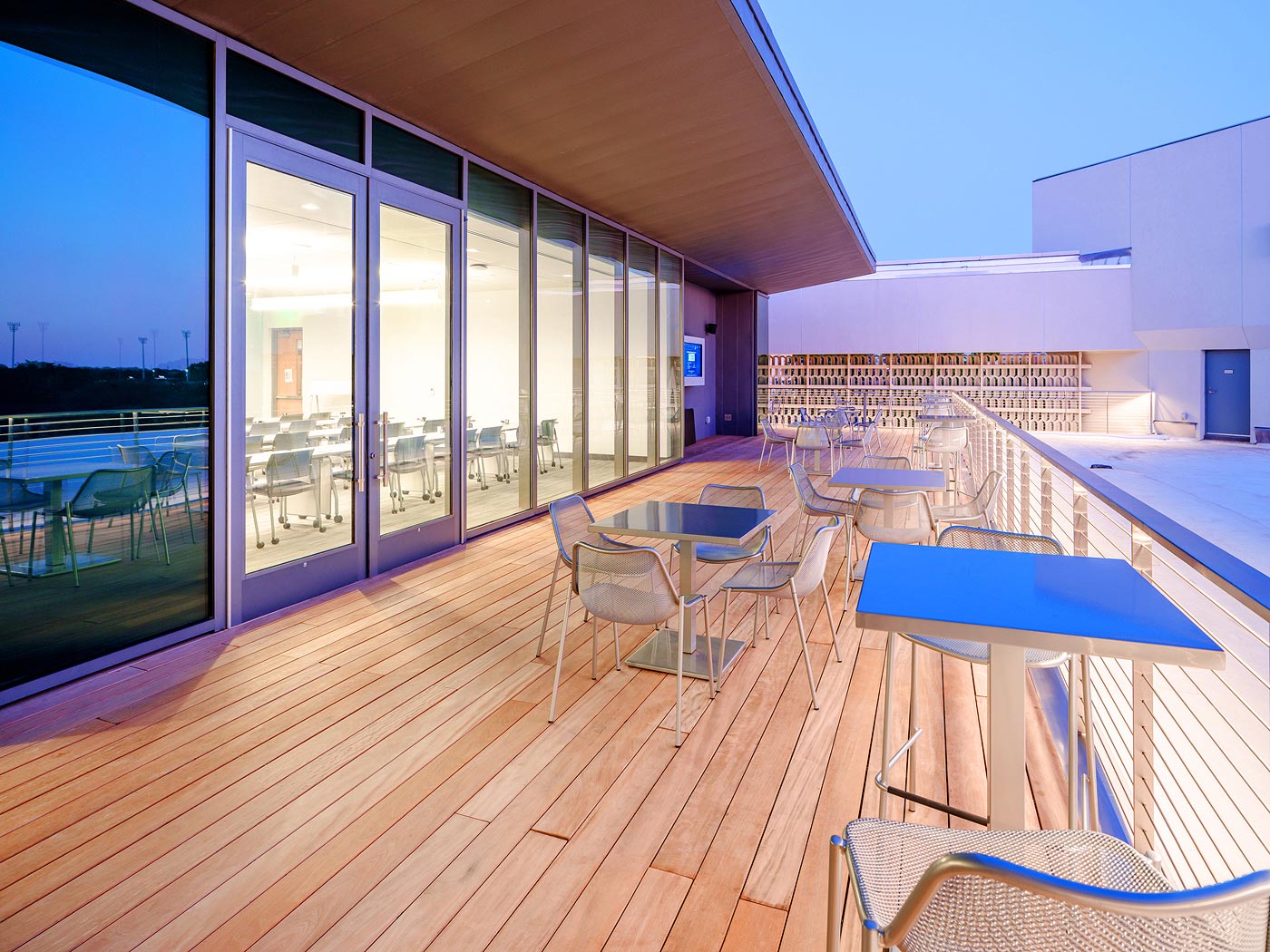 The rooftop terrace includes an AV alcove with 55” flat panel display and a sound system producing 200 watts of audio. From this angle, the flat panel display is visible at the far end of the terrace.