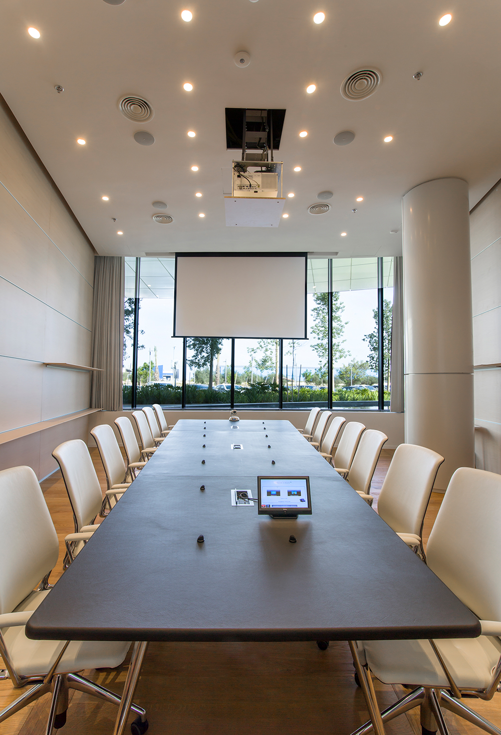 In the boardroom, Extron DTP T USW 233 switchers mounted beneath the table send signals to the matrix switcher.