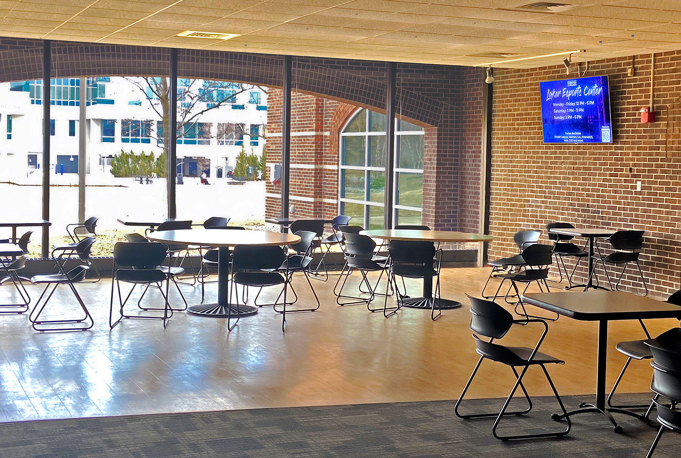 The wall-mounted displays within the dining hall enable spectators to share in the gaming experience without crowding the players.