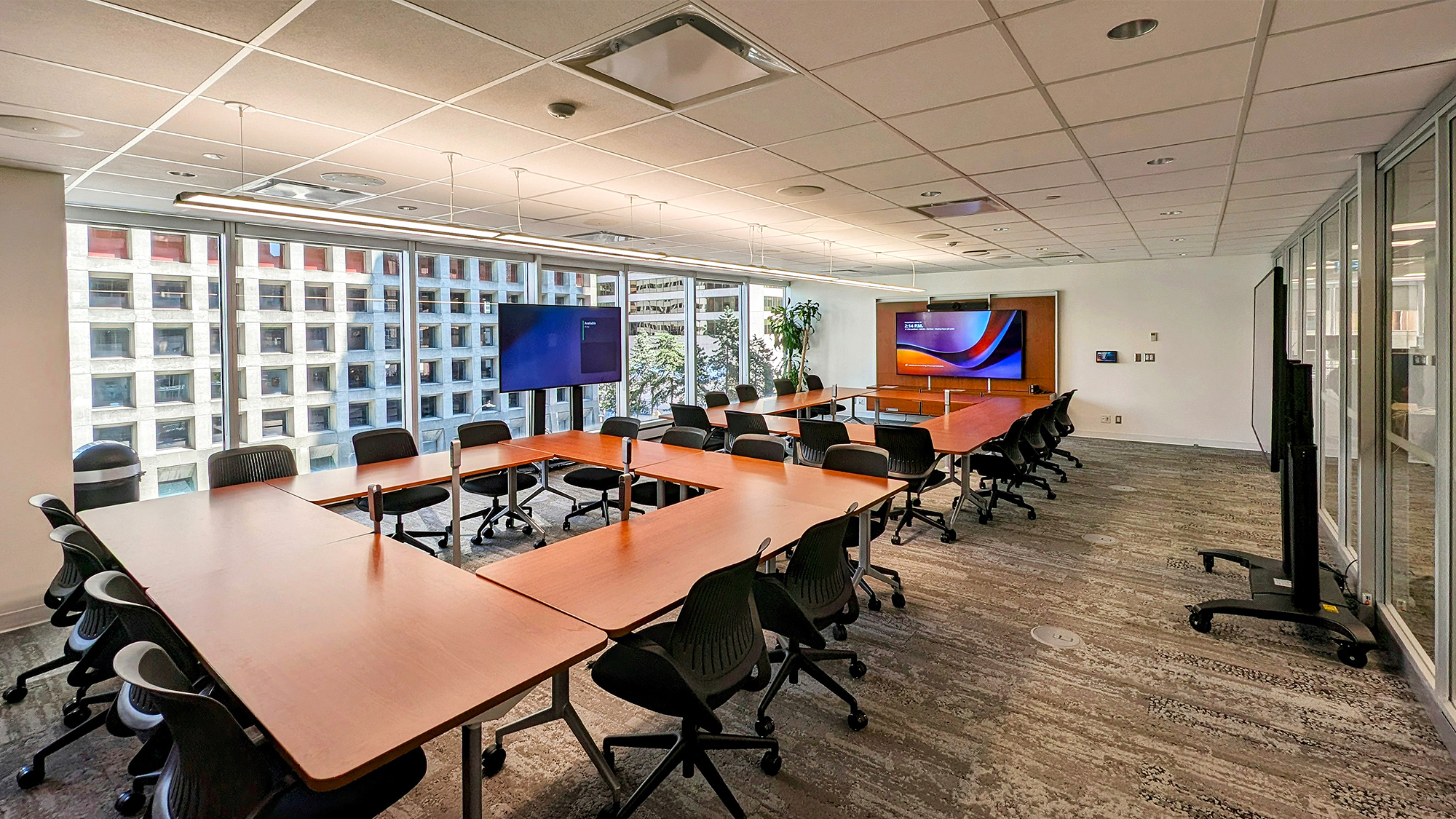 The large conference tables are positioned to take full advantage of the room’s AV capabilities, ideal for executive meetings and company-wide presentations.