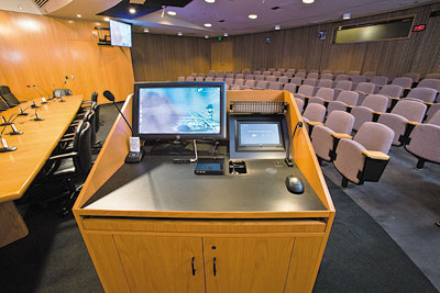 To control presentation from within the boardroom, an Extron TLP 1000MV 10", Wall Mount TouchLink® Touchpanel is embedded in the lectern next the ELO touch screen monitor.