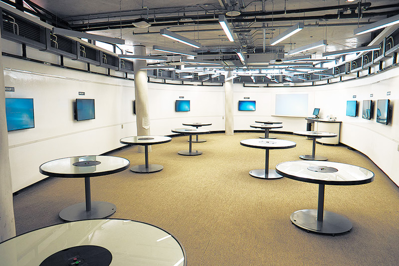 Student tables with wall-mounted flat panel displays