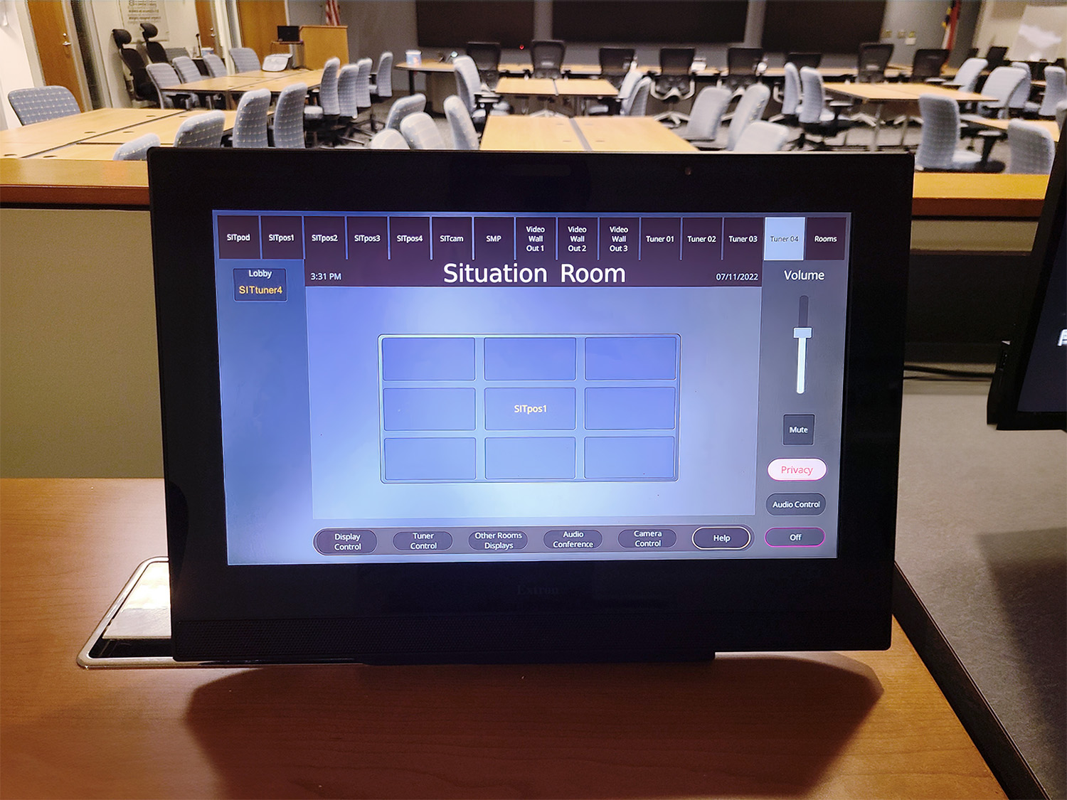 AV signals from sources such as computers running specialized software, broadcast news feeds, and devices connected at the tables are sent to one or more of the displays, with all operations controlled by an Extron 15" tabletop TouchLink Pro touchpanel at the head table.