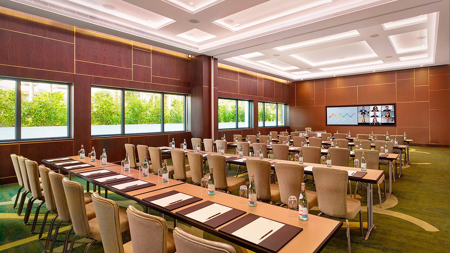 Meeting room with chairs facing forward towards the wall-mounted displays