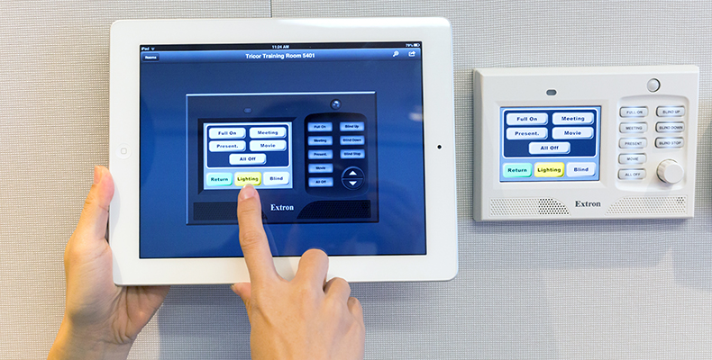 The Extron Control app replicates the control interface of the wall-mounted TouchLink controller, providing real-time status and remote control of the AV system from an iPad.