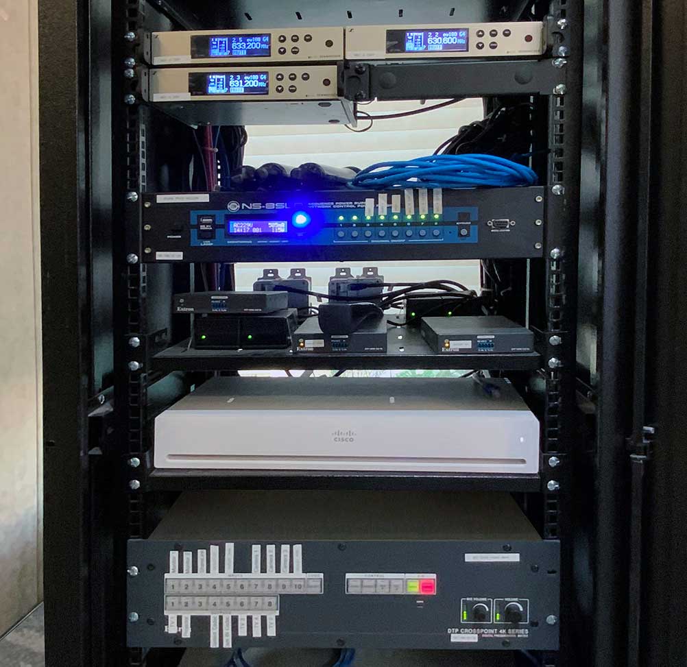 Each room is serviced by a single-bay AV equipment rack.