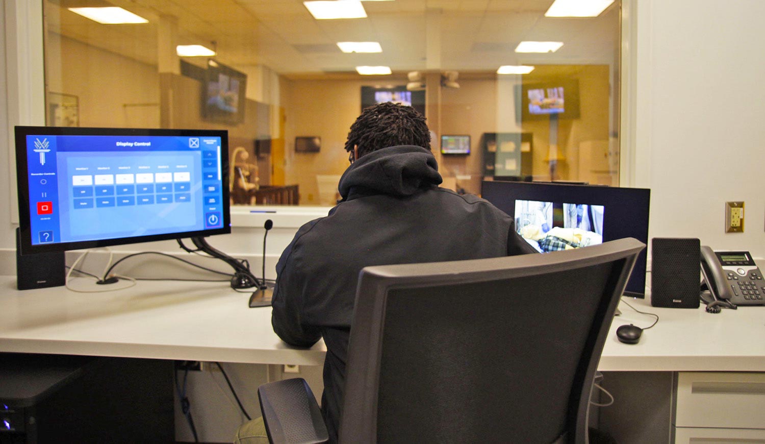 Instructor conducts a training session in the control room of the Emergency Medical Services simulation suite.