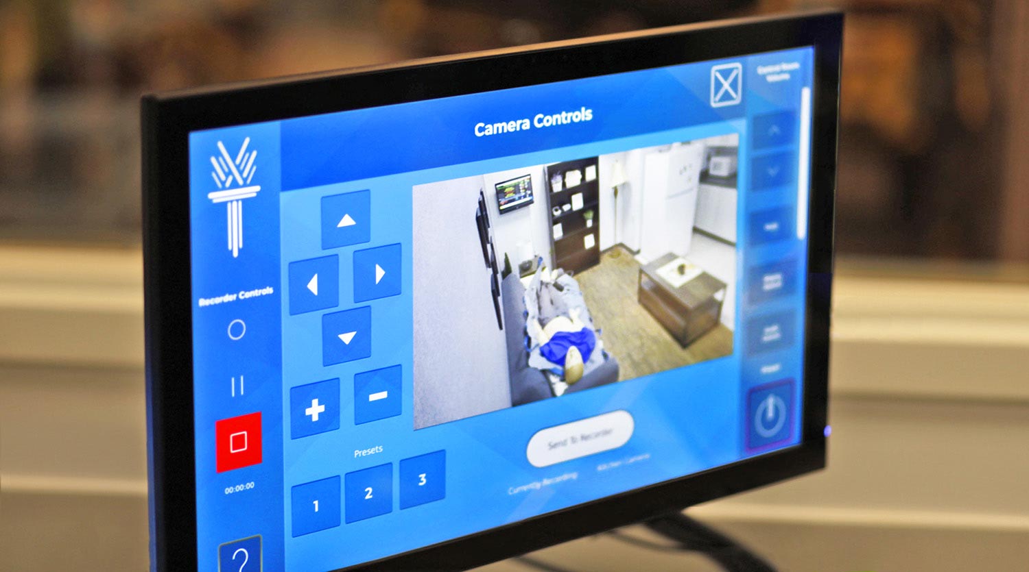 A 24” touchscreen controls all AV functions including PTZ camera positioning. The touchscreen connects to the Extron control processor via a TLI Pro 101 TouchLink interface.