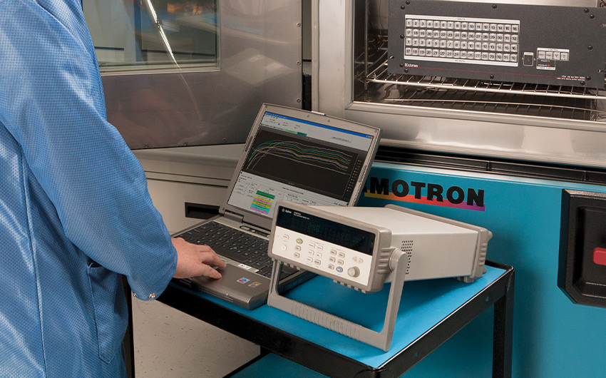 Worker performing environmental testing on an Extron switcher.